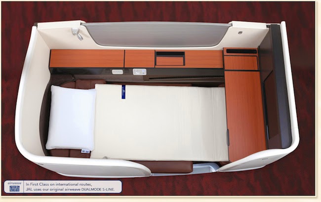 an airplane bed with a white pillow