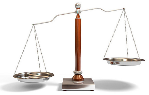 a balance scale with two silver bowls