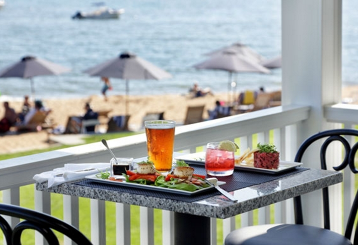 a table with food on it and drinks on the beach