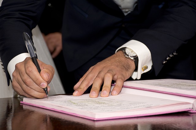 a man signing a document