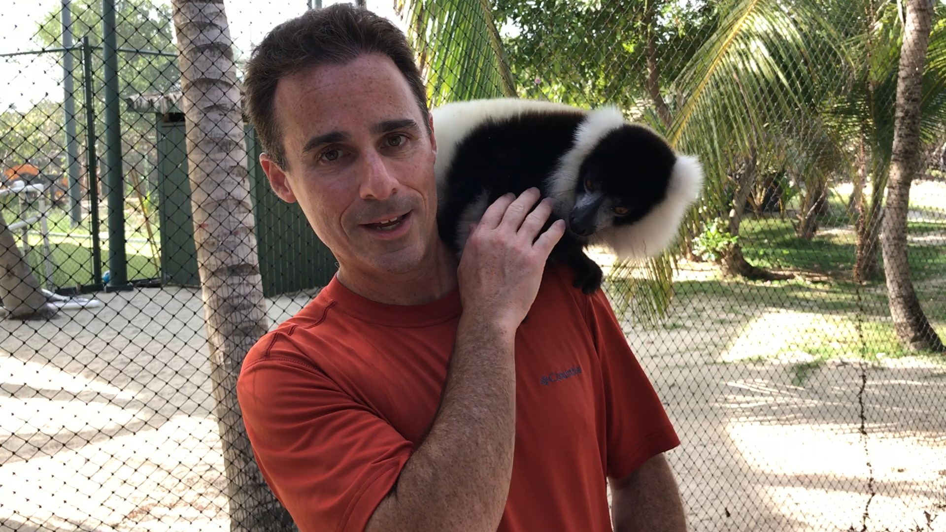 a man holding a black and white animal