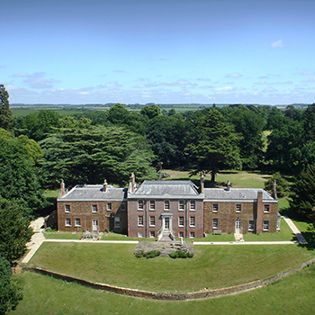 a large brick building surrounded by trees