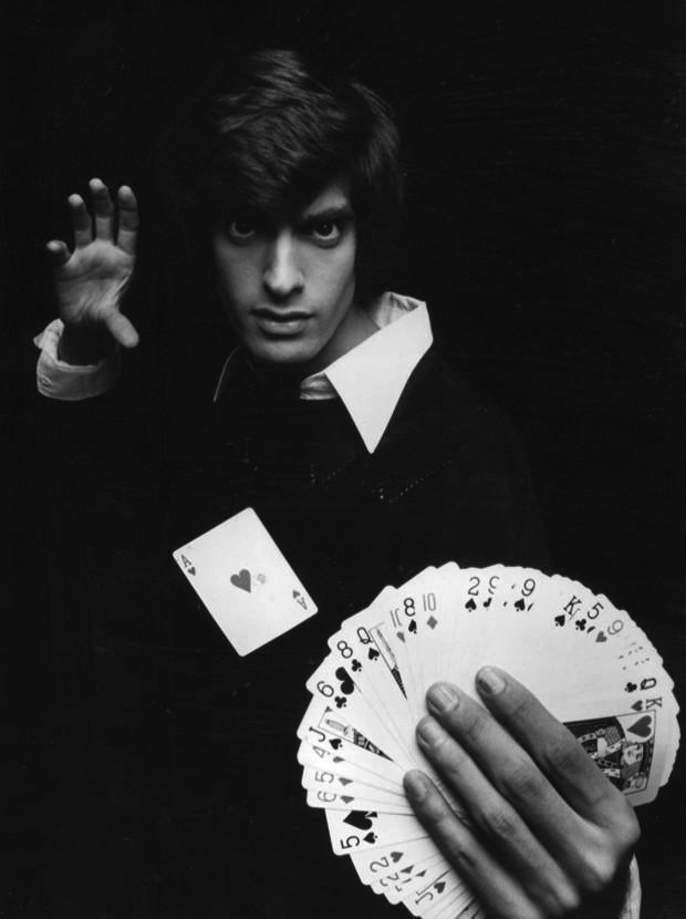 a man holding a deck of cards