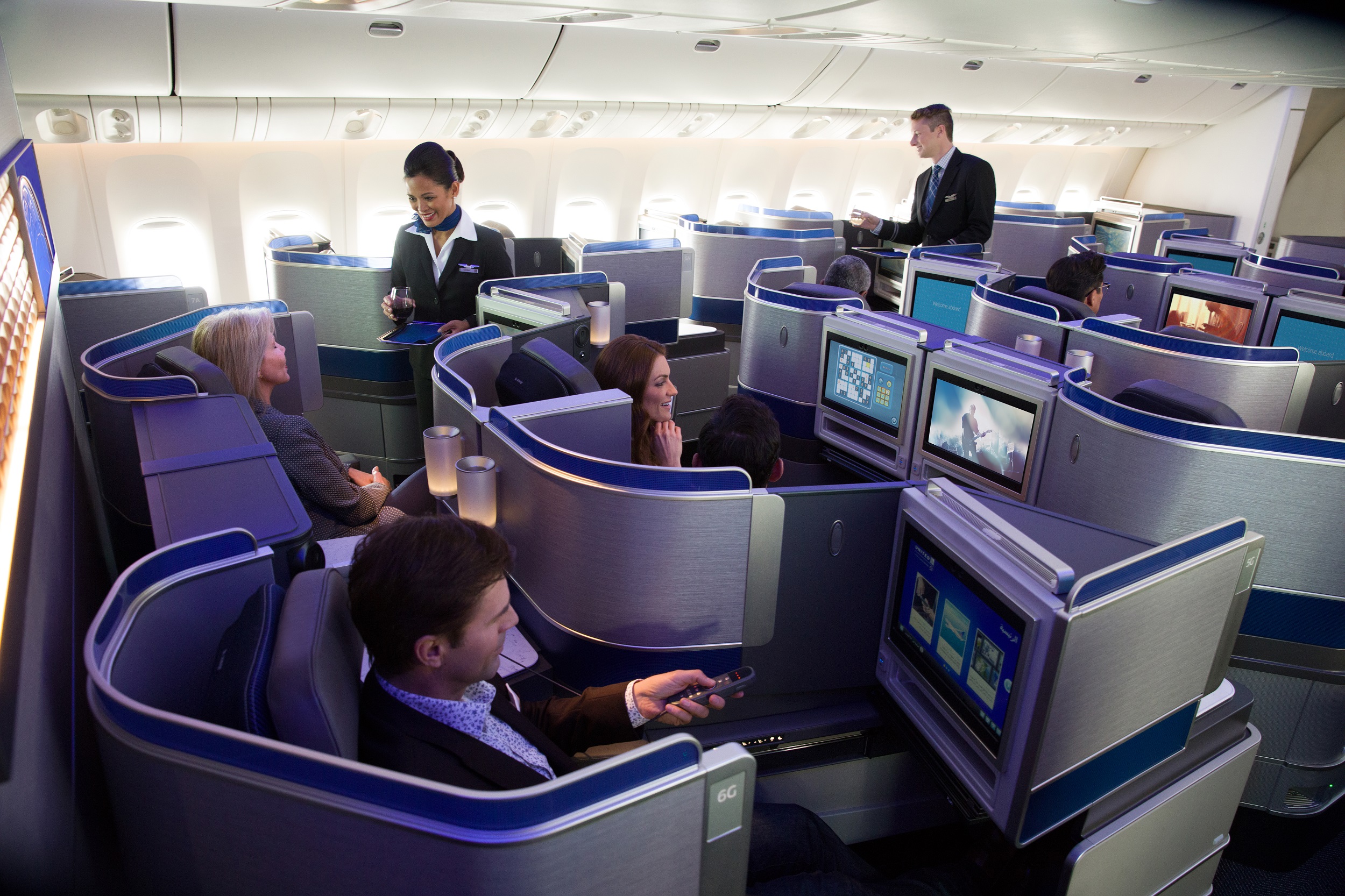 a group of people sitting in chairs in an airplane