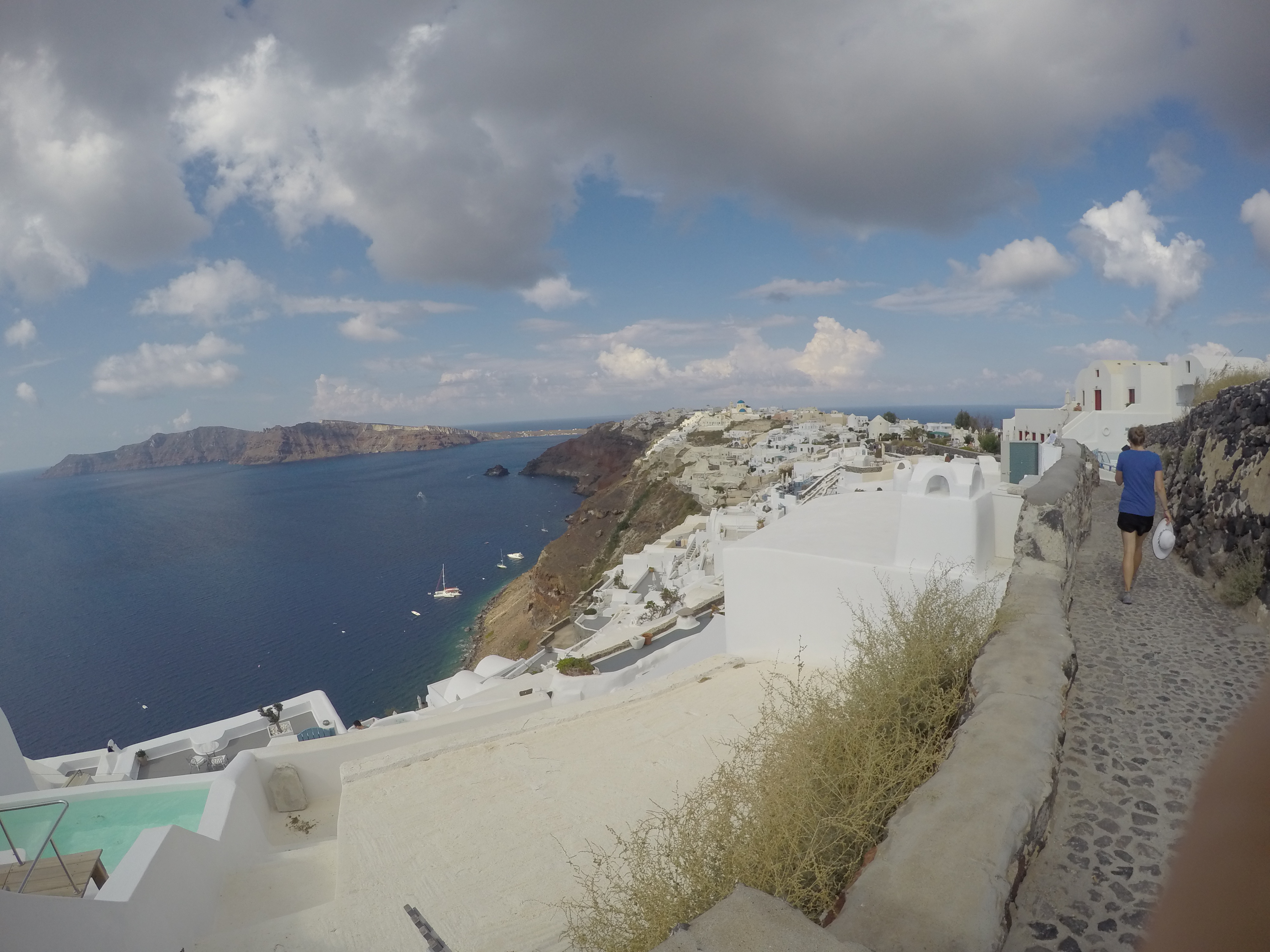 a white buildings on a cliff overlooking a body of water