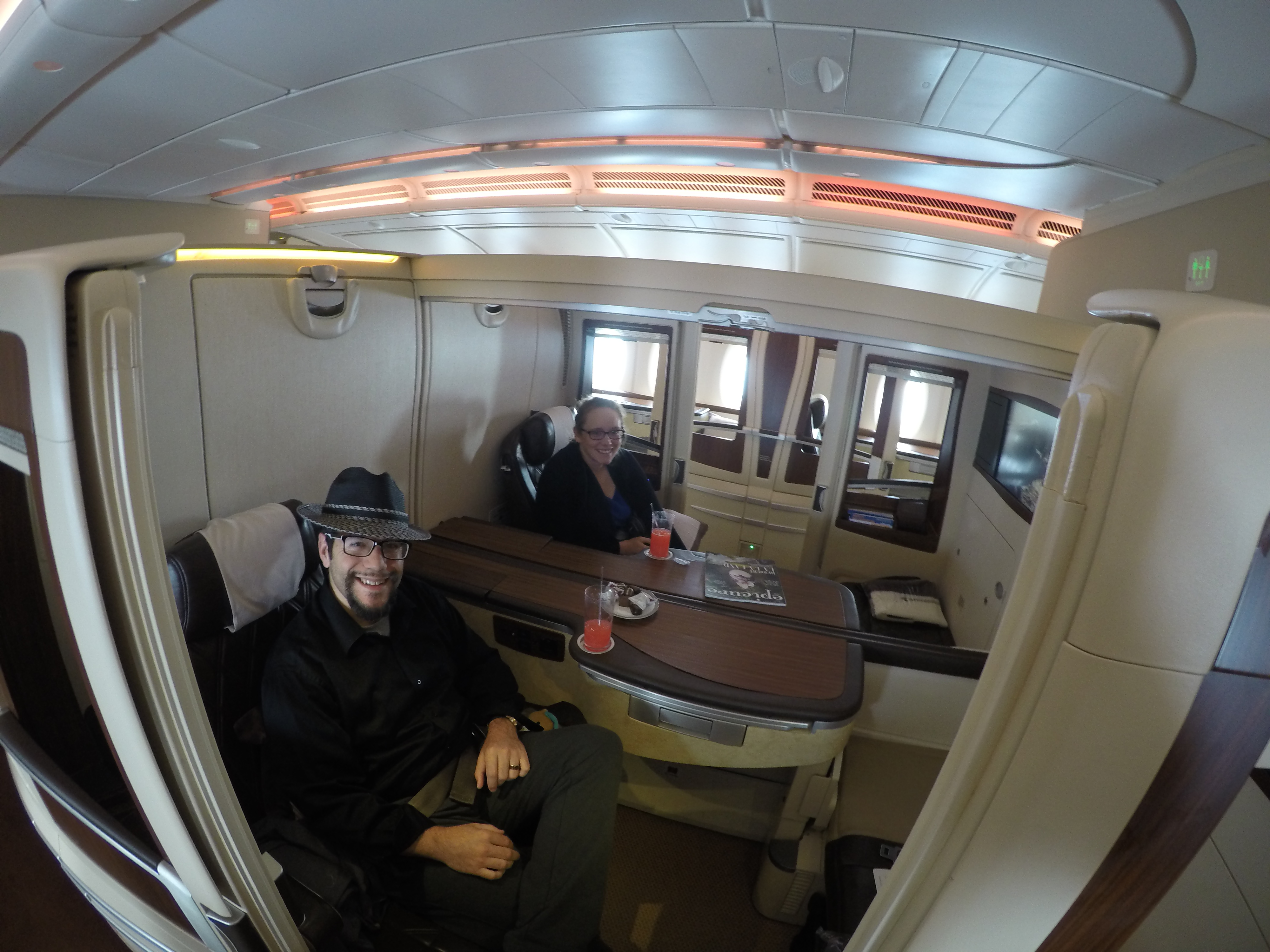 a man and woman sitting in a chair in a plane