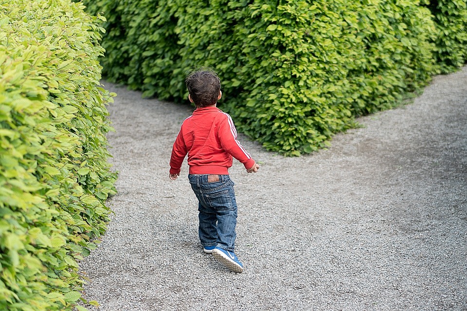 a child walking on gravel path