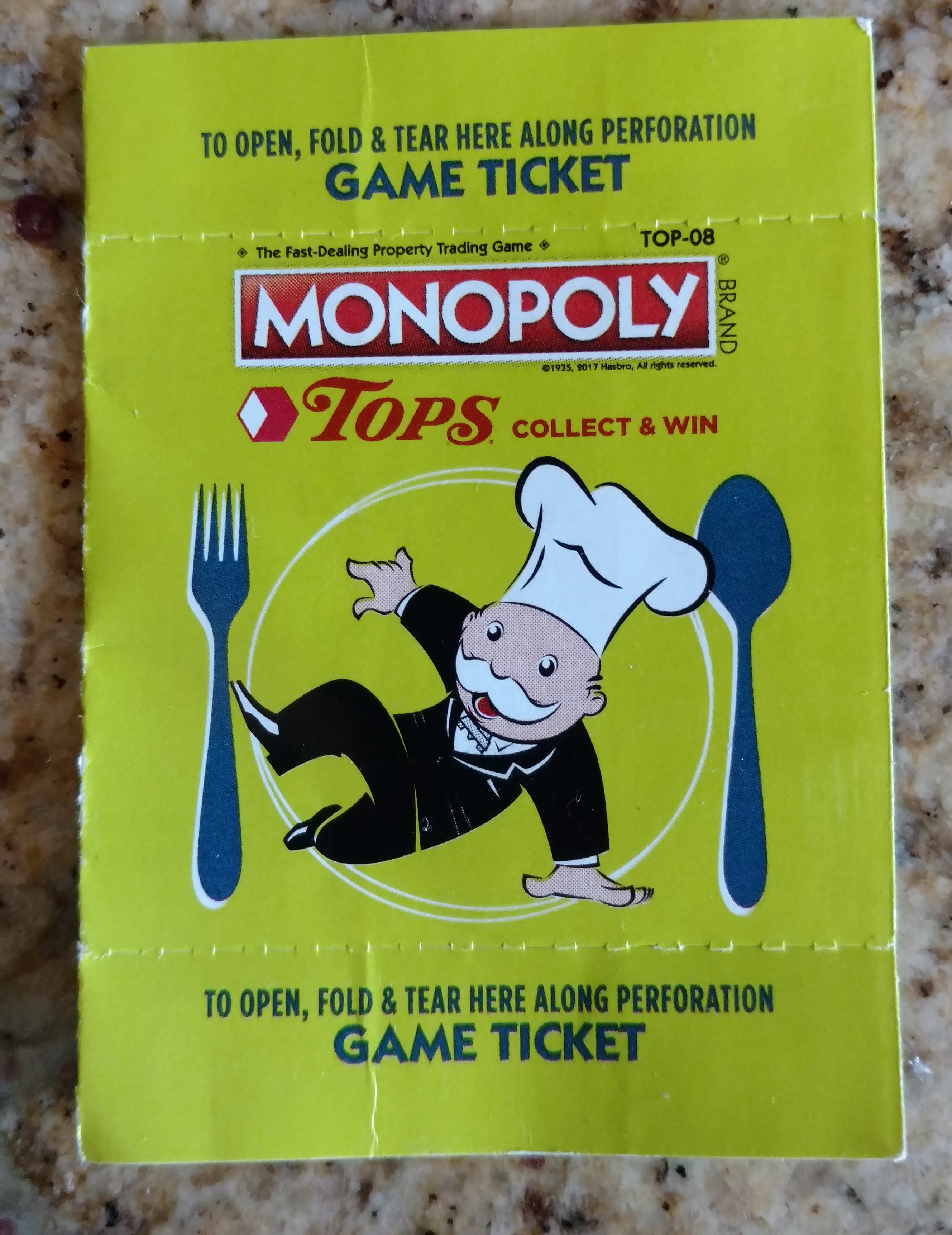 a yellow ticket with a cartoon character on it