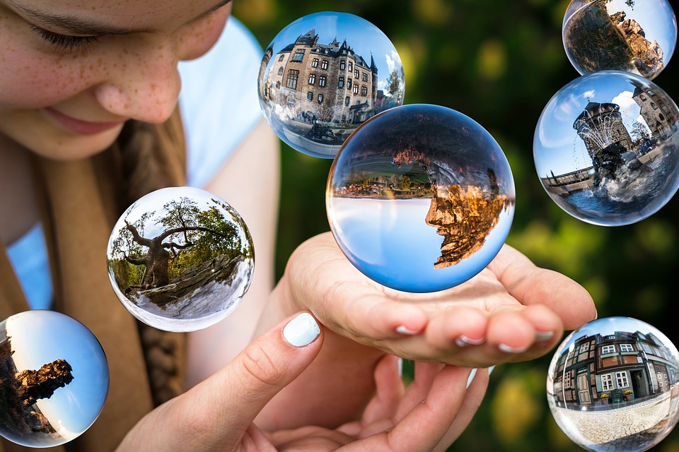 a person holding a ball with a picture of a landscape
