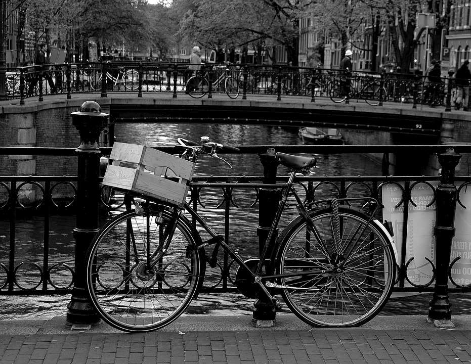a bicycle leaning against a railing