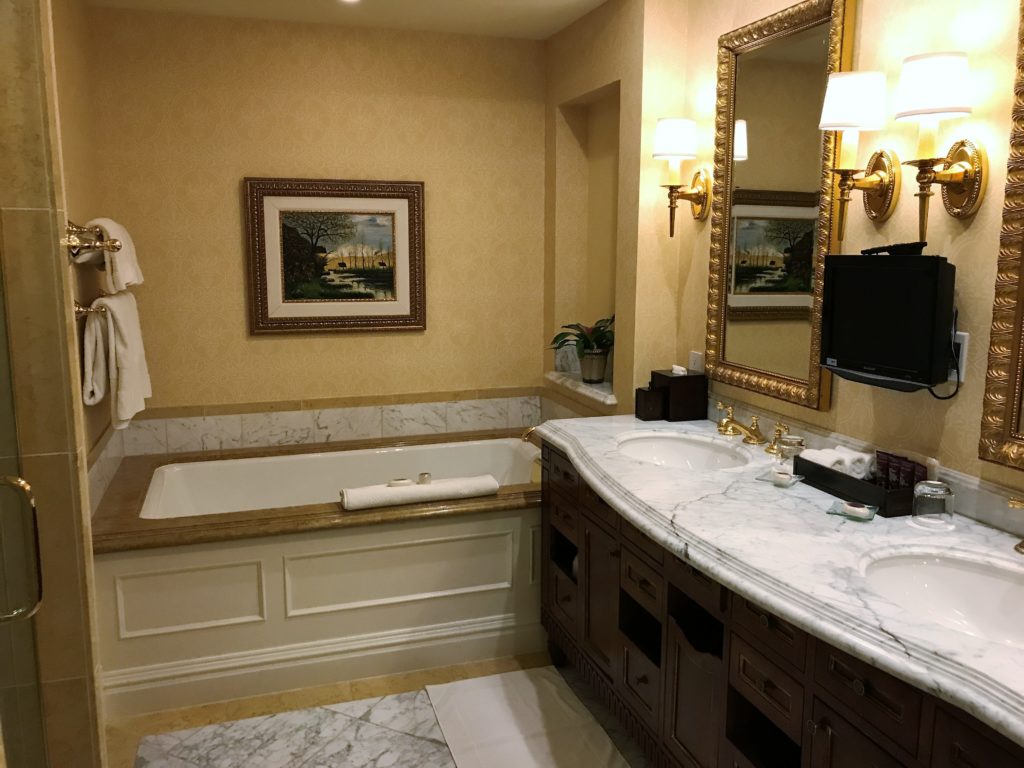 a bathroom with a tub and a mirror