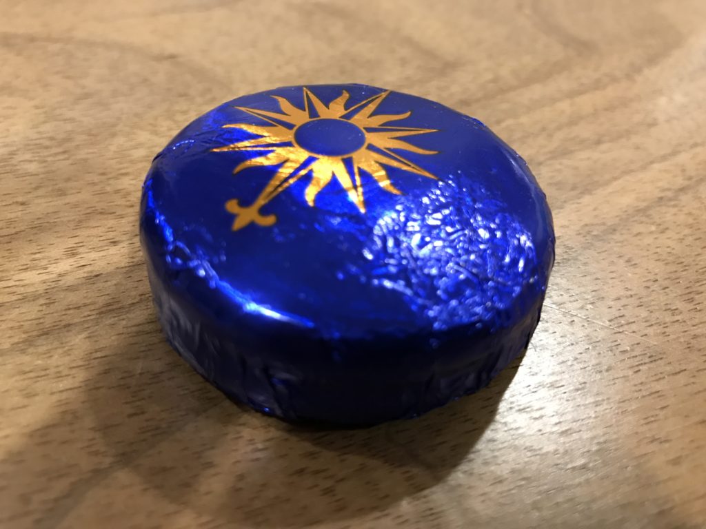 a blue round object with a yellow sun on it