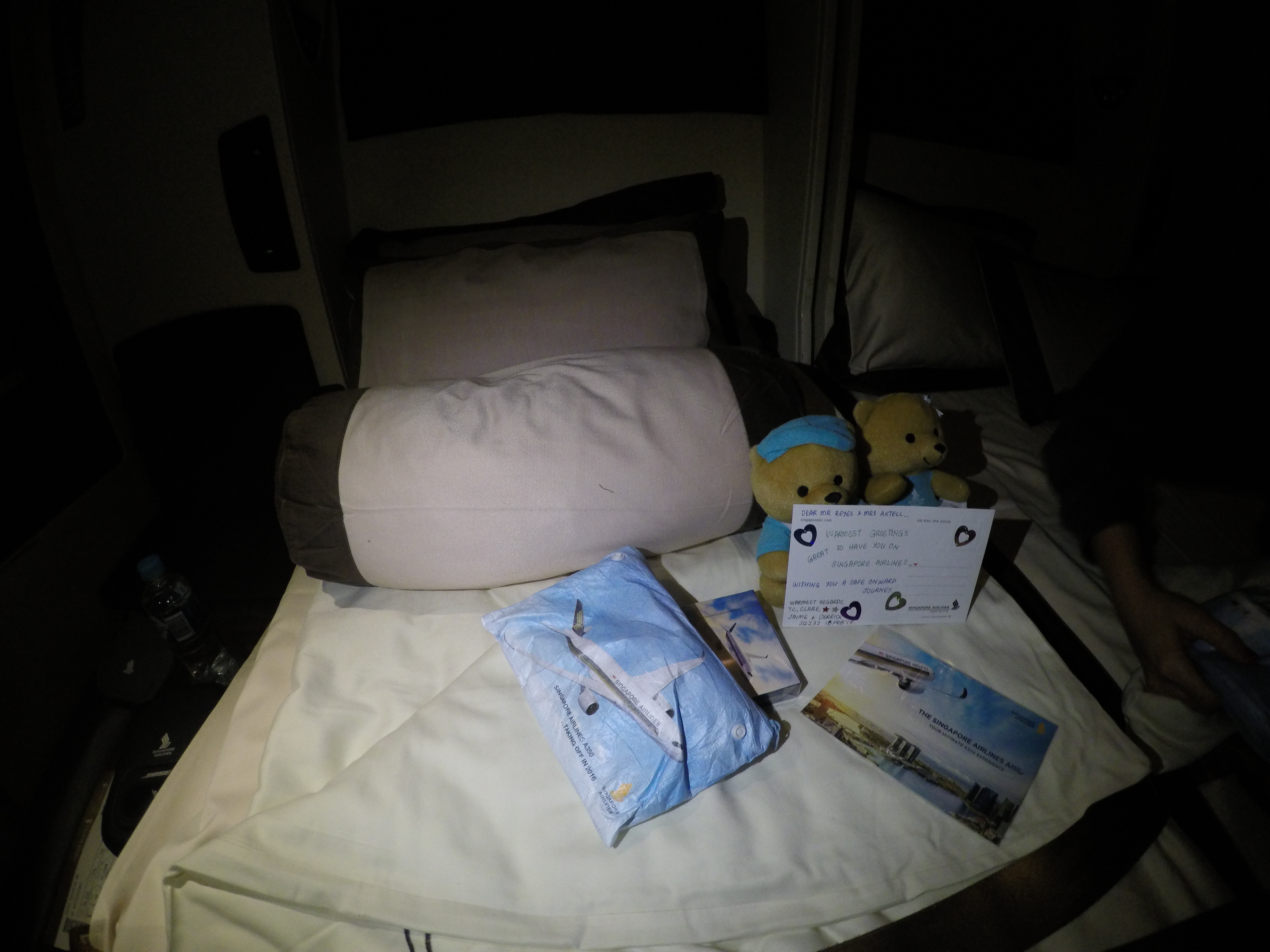 a bed with a couple of teddy bears and a card