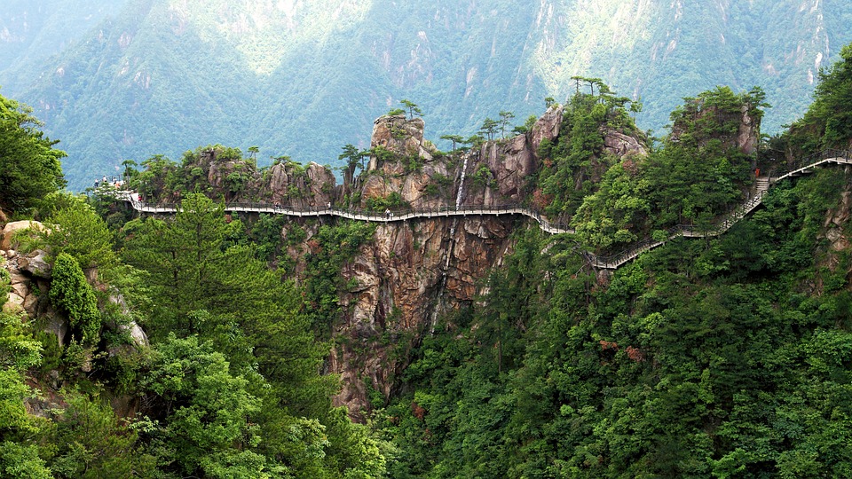 a long wooden walkway on a cliff