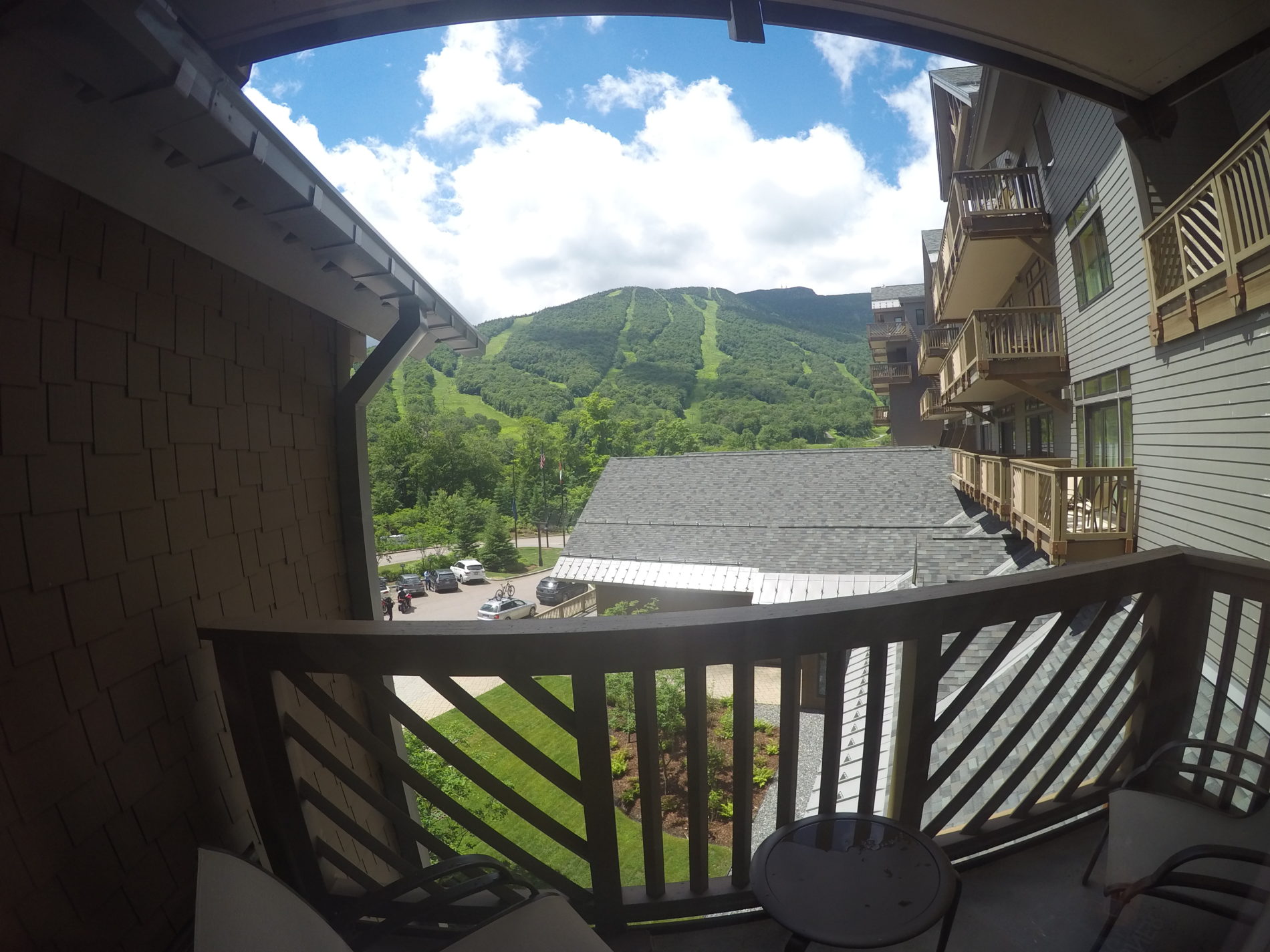 a balcony with a view of a mountain and trees