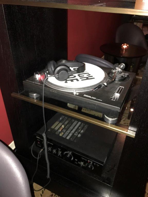 a record player with headphones on a table