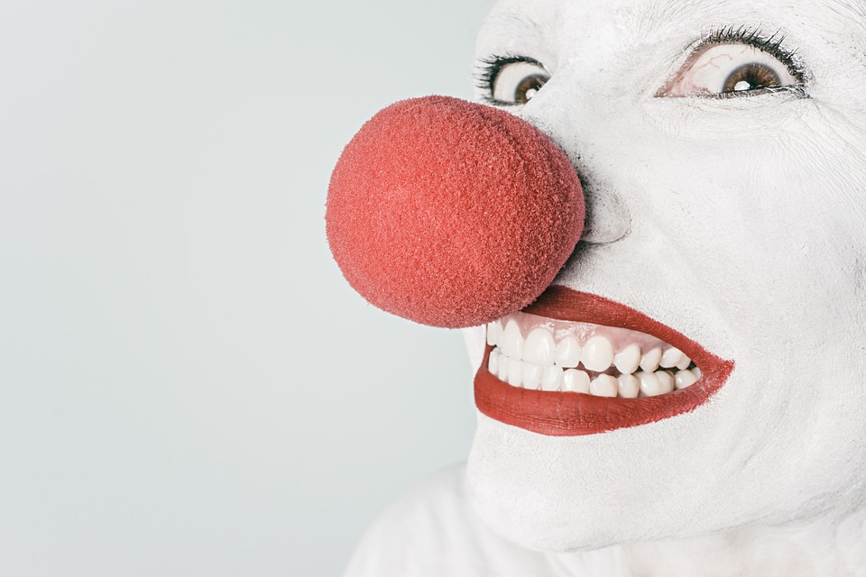 a person with white face and red nose