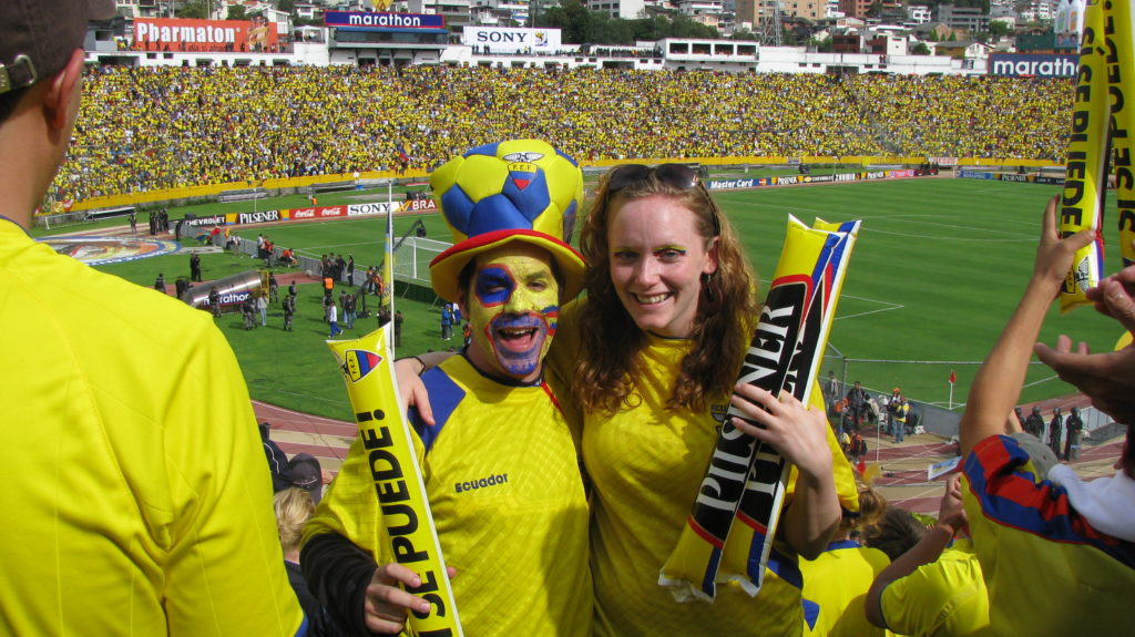 a couple of people in yellow and blue uniforms posing for a picture