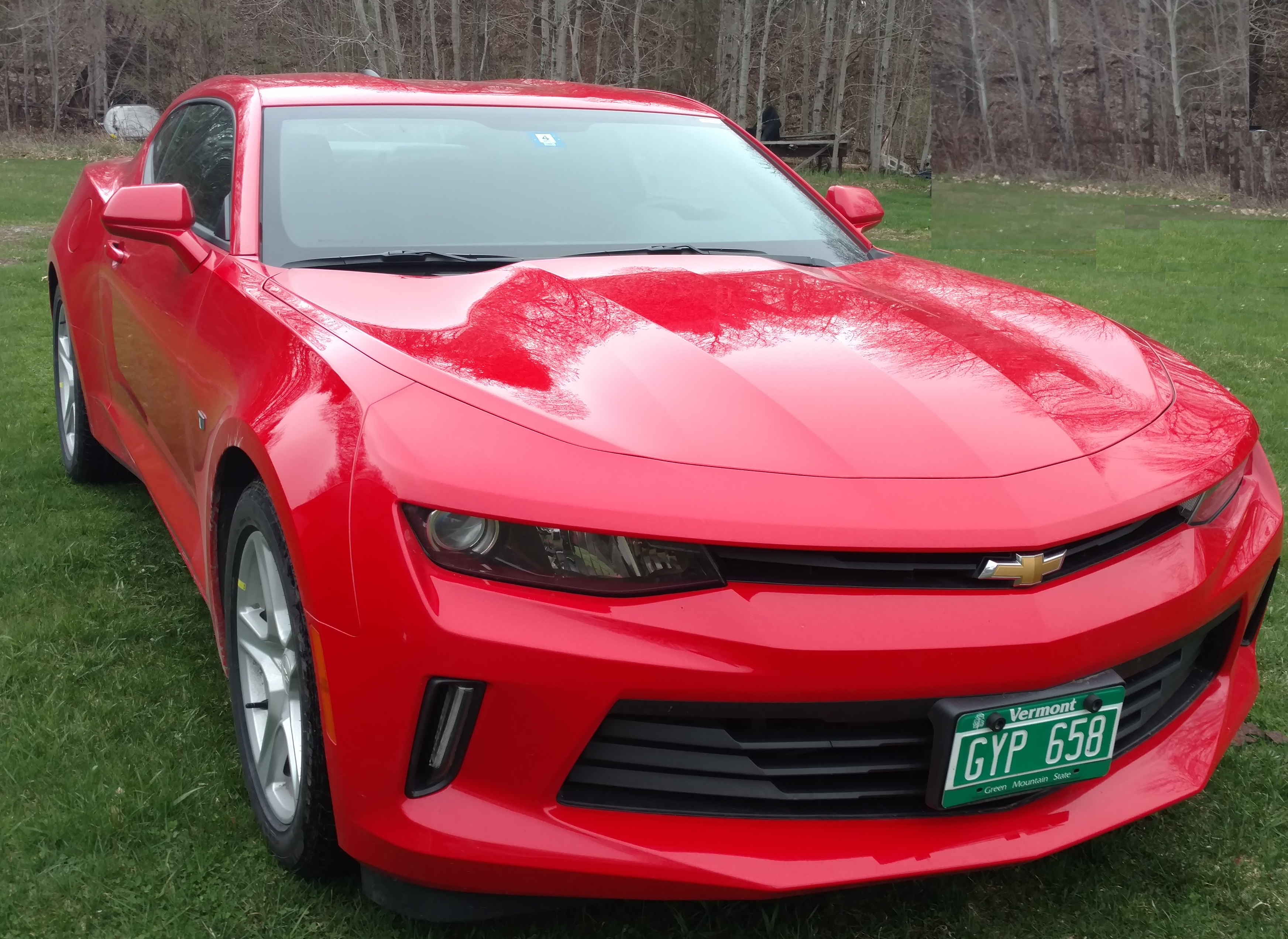 a red car parked on grass