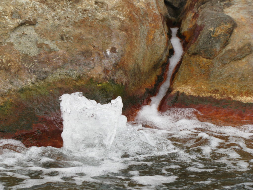 a water splashing out of a rock