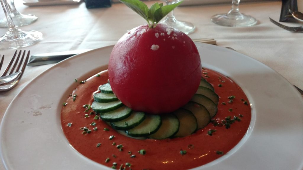 a tomato and cucumber on a plate