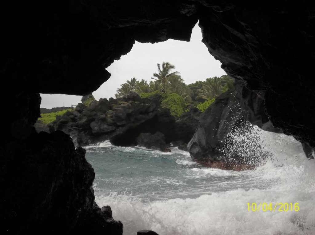 a cave with waves crashing into rocks