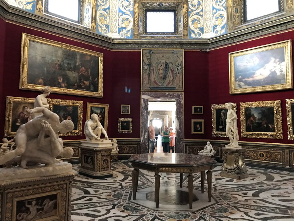 a room with statues and paintings