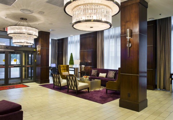 a lobby with a purple couch and chairs