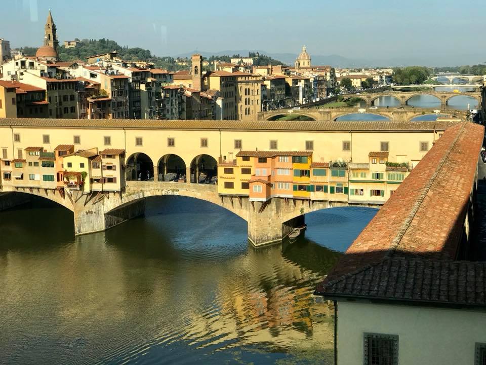 Ponte Vecchio over water with buildings in the background
