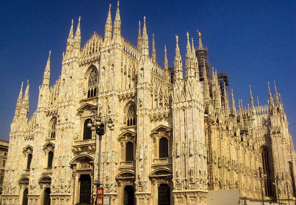 a large stone building with many spires with Milan Cathedral in the background