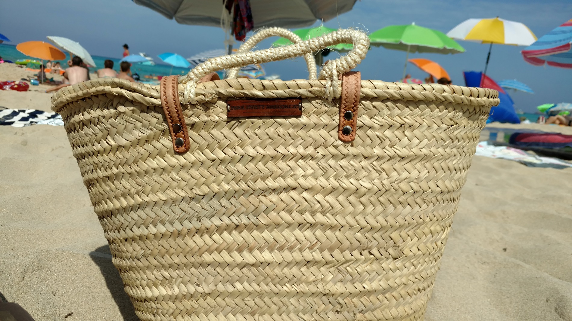 a woven basket on the beach