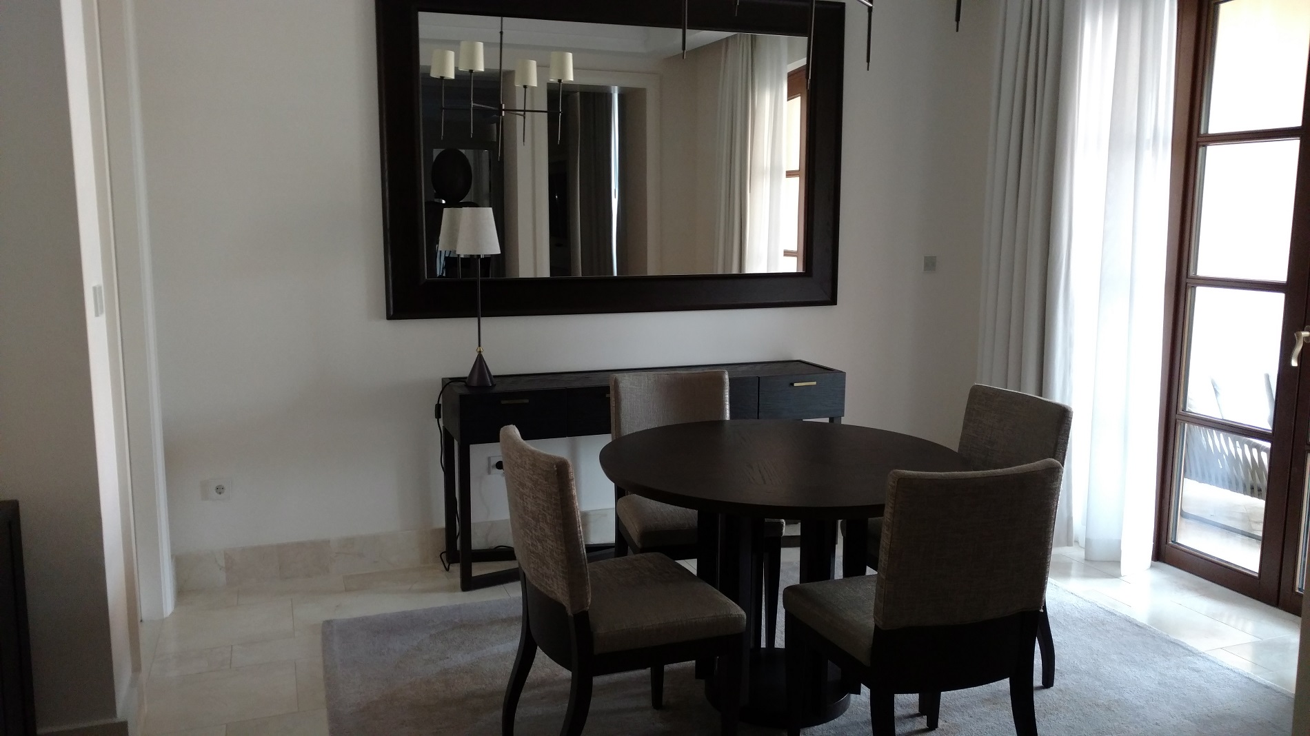 a dining room with a mirror and a table