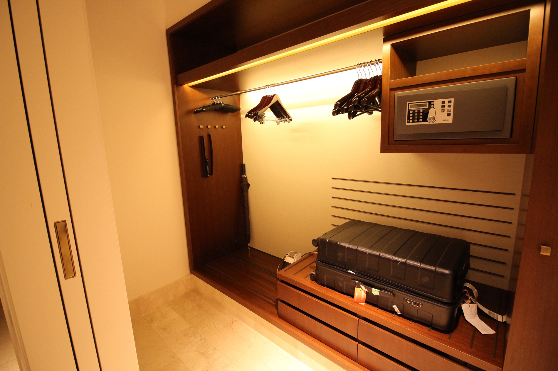 a room with a closet and a suitcase