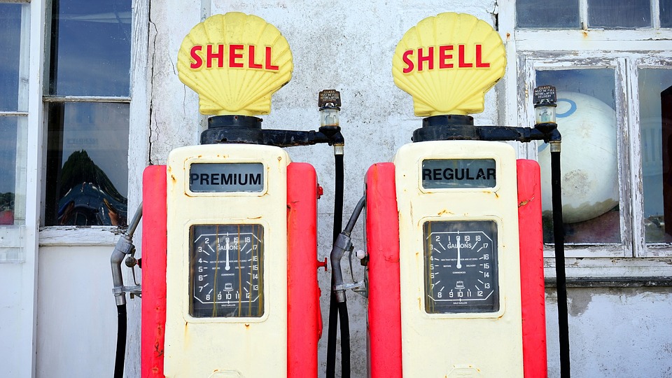 a couple of gas pumps with a shell sign