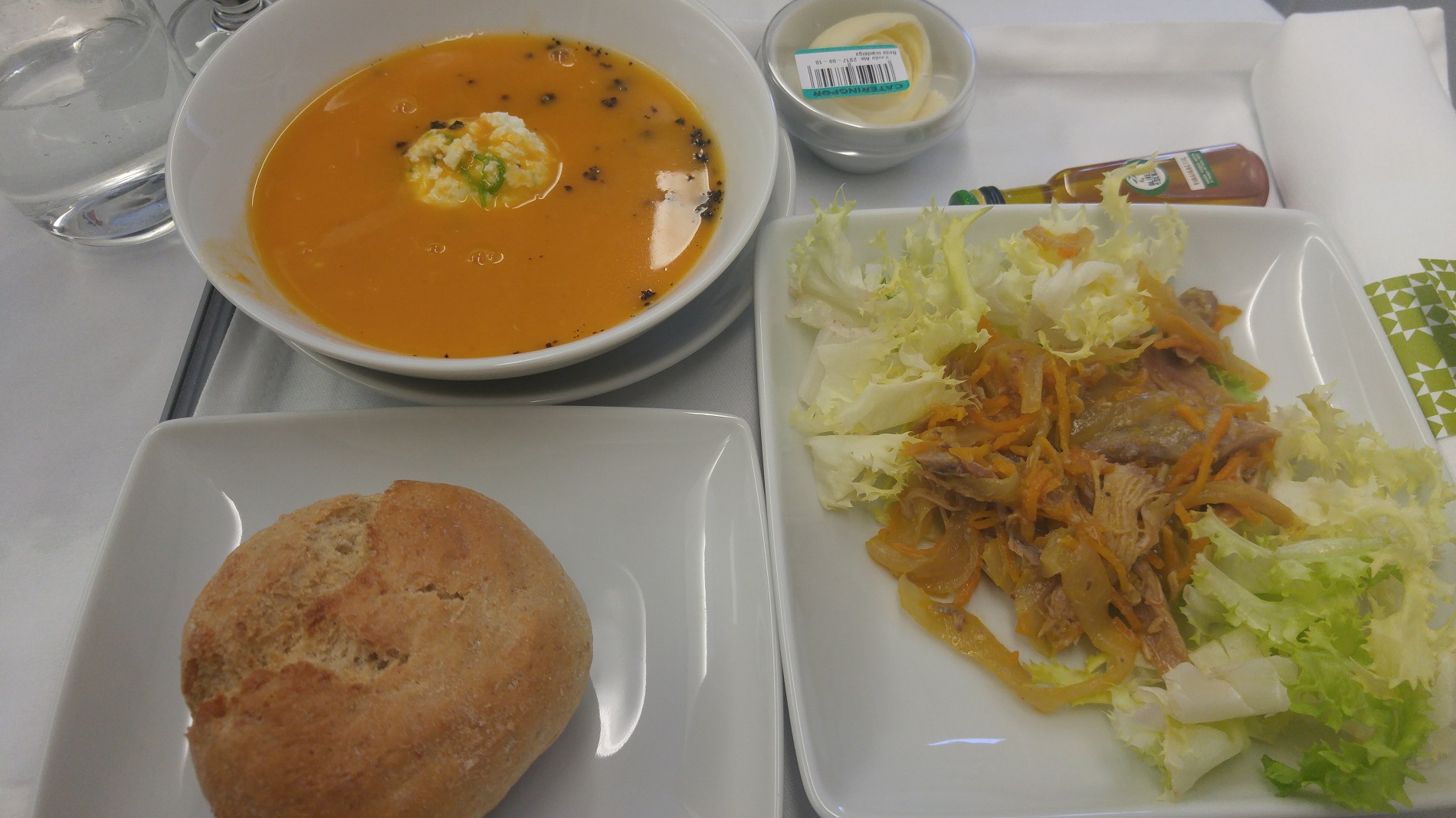 a plate of soup and salad on a table
