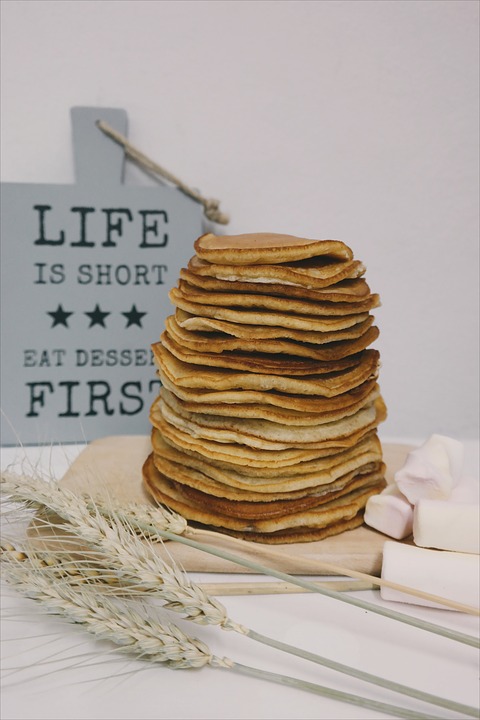 a stack of pancakes on a wooden board