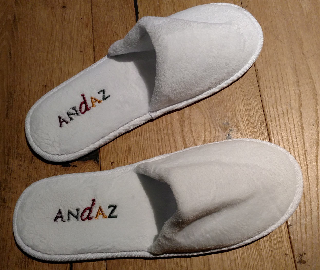 a pair of white slippers with text on them
