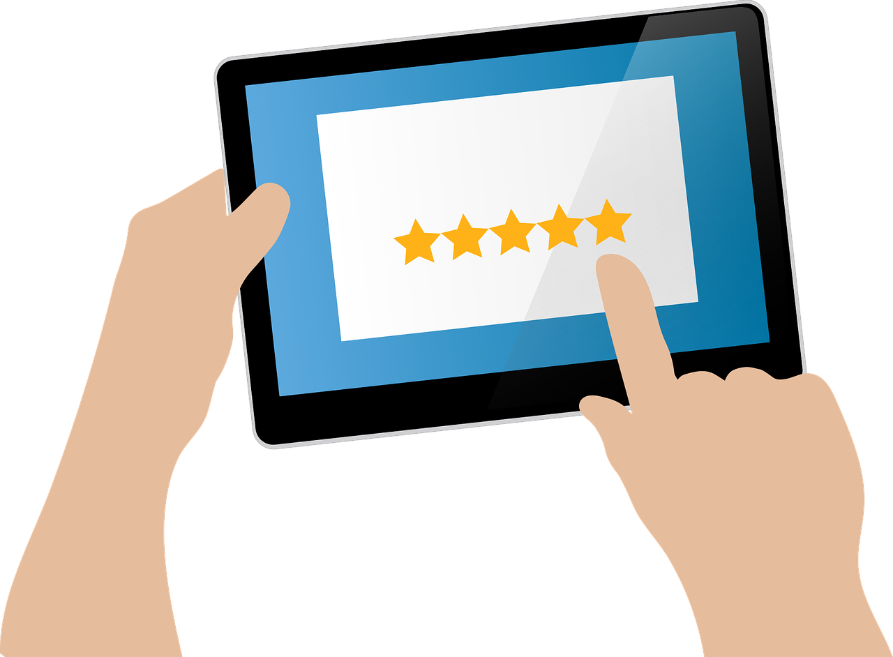 a hand holding a tablet with a five star rating