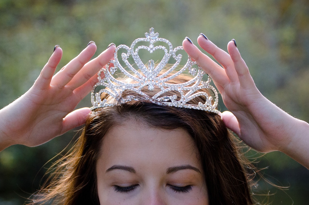 a woman holding a tiara