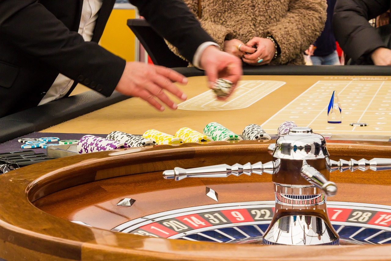 a roulette table with a person placing a dice