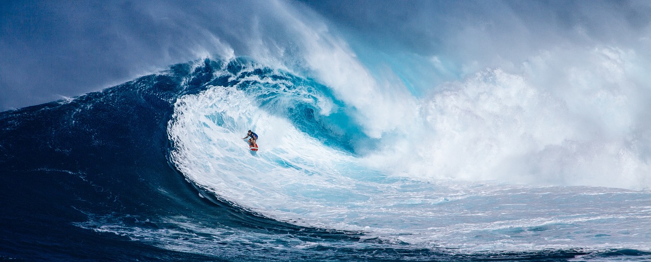 a person surfing on a large wave