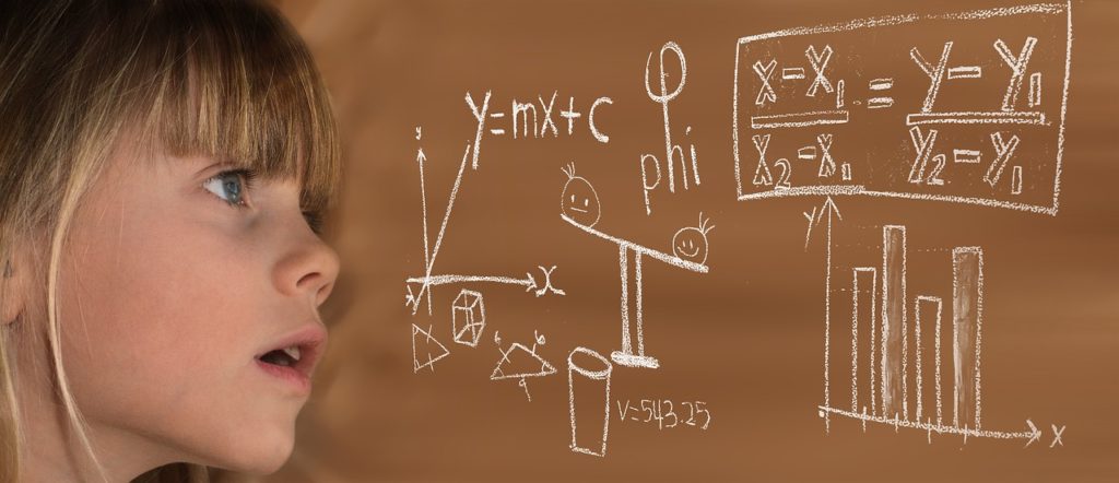 a child writing on a board