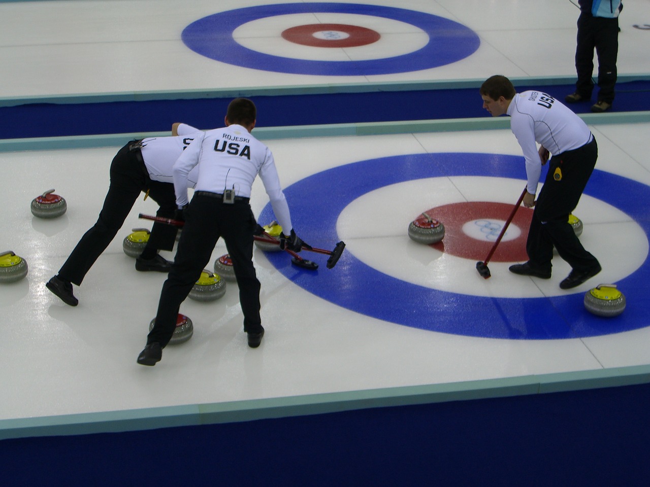 men curling players on the ice