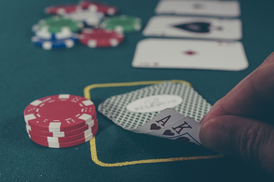 a hand holding a pair of cards