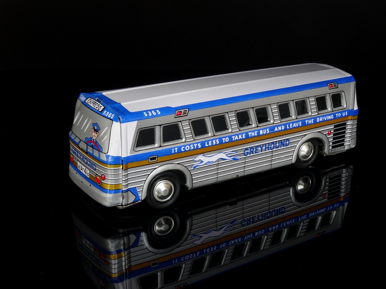 a toy bus on a black surface