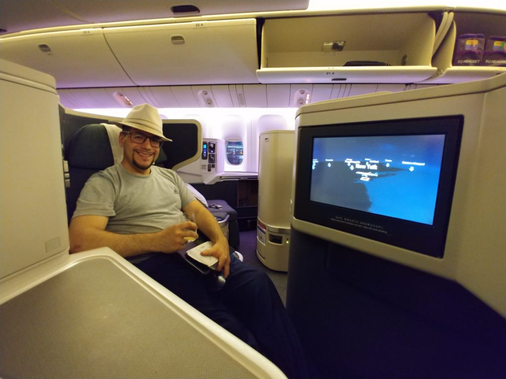 a man sitting in a chair with a television