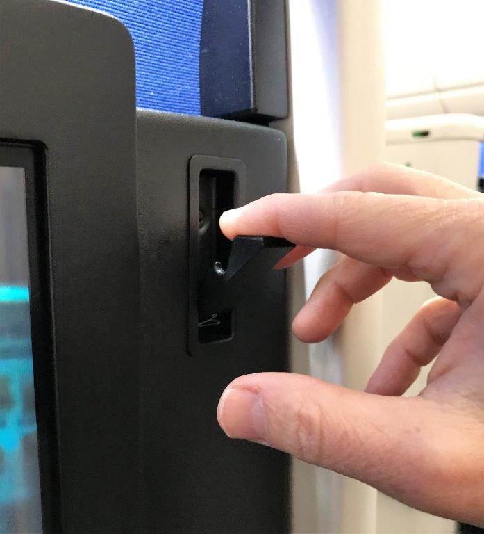a person's hand pressing a button on a device