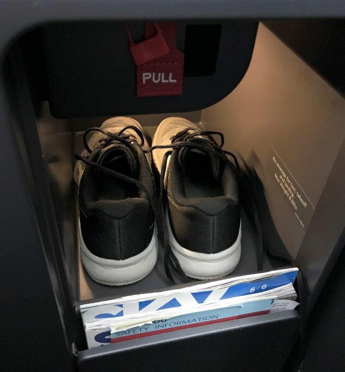 a pair of black shoes in a drawer