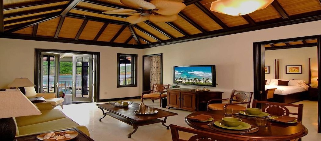 a living room with a television and a ceiling fan