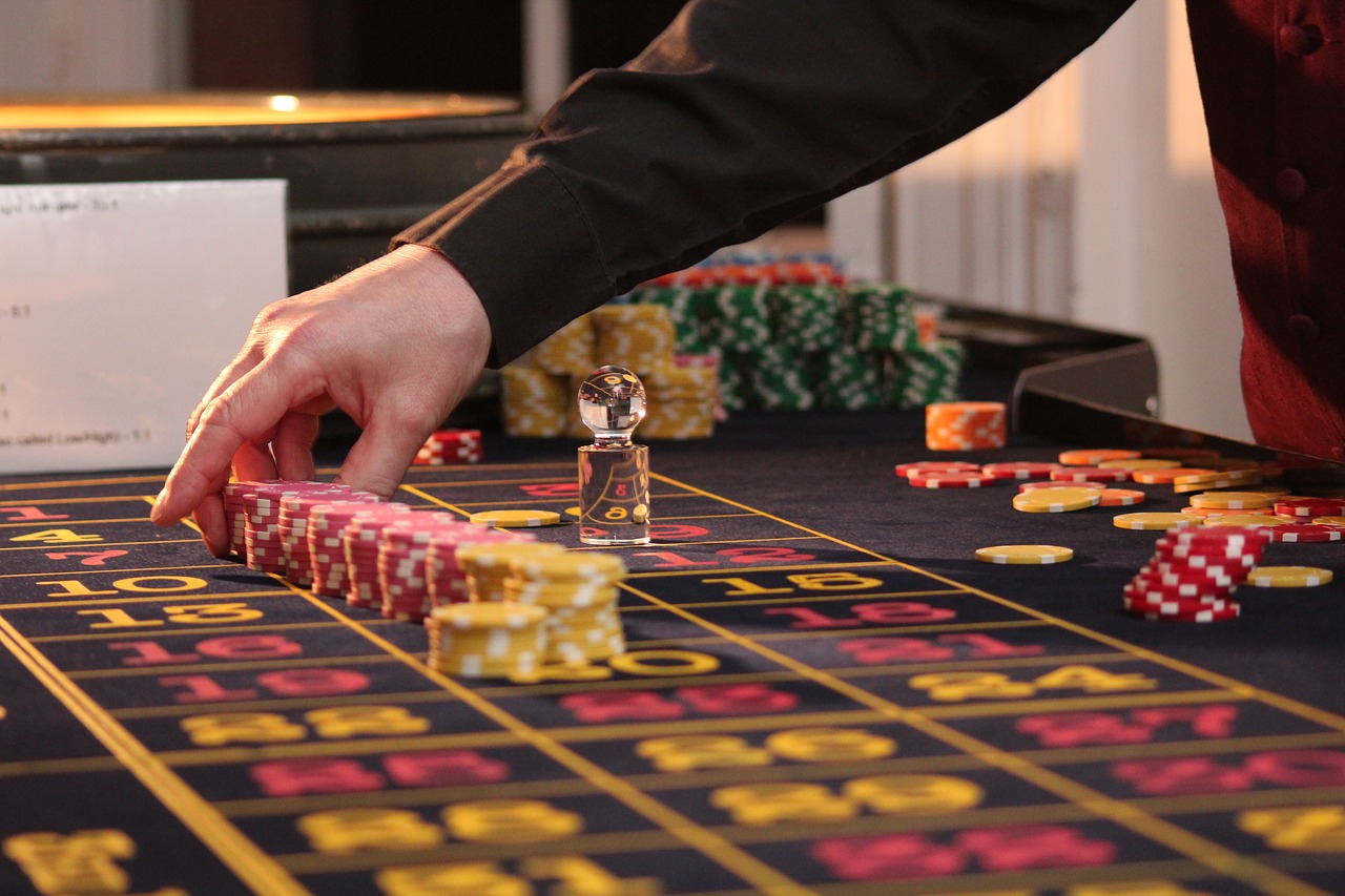 a hand placing poker chips on a table